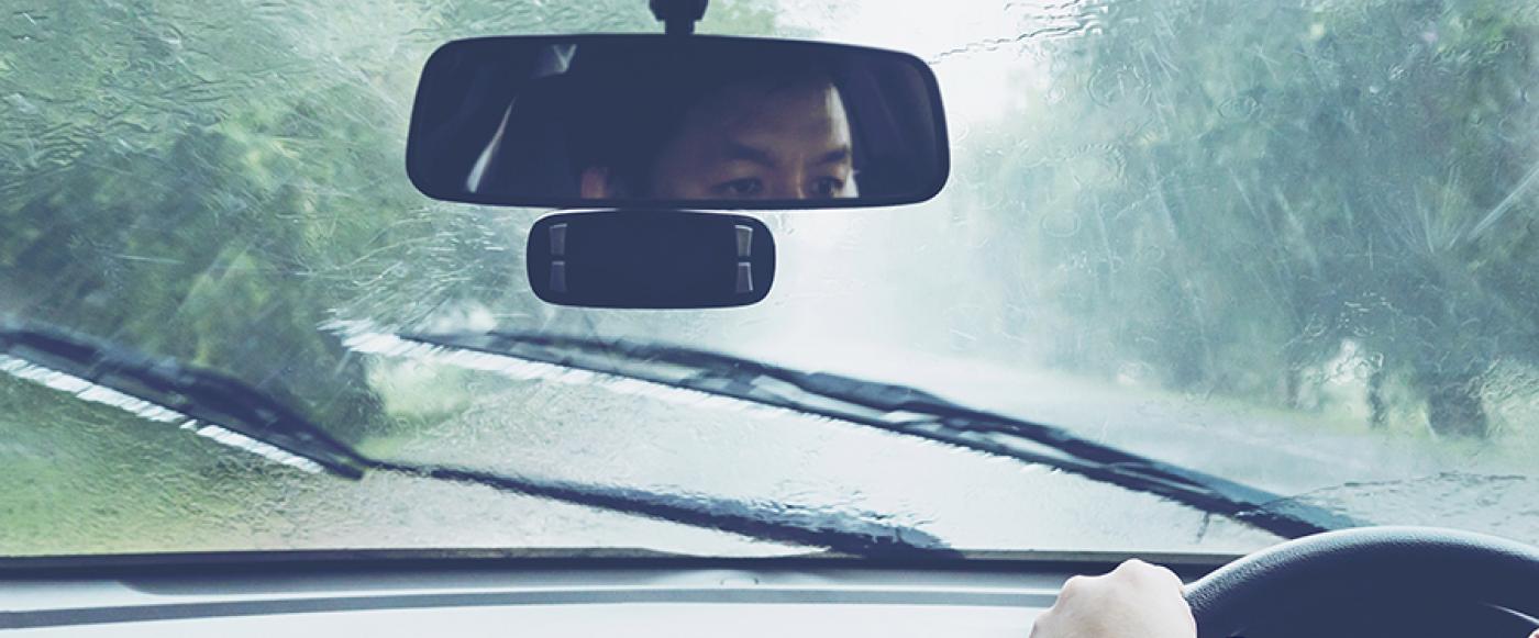 Man driving car in heavy rain