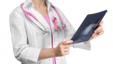Doctor with pink ribbon for breast cancer awareness