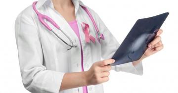 Doctor with pink ribbon for breast cancer awareness
