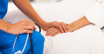 Nurse holding elderly ladies hand - aged care