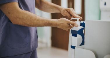 Male nurse disinfecting his hands