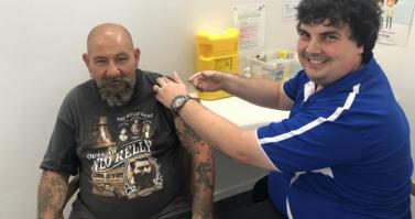 Pharmacist Andrew Gilberto from Hinchinbrook Community Pharmacy vaccinates a patient