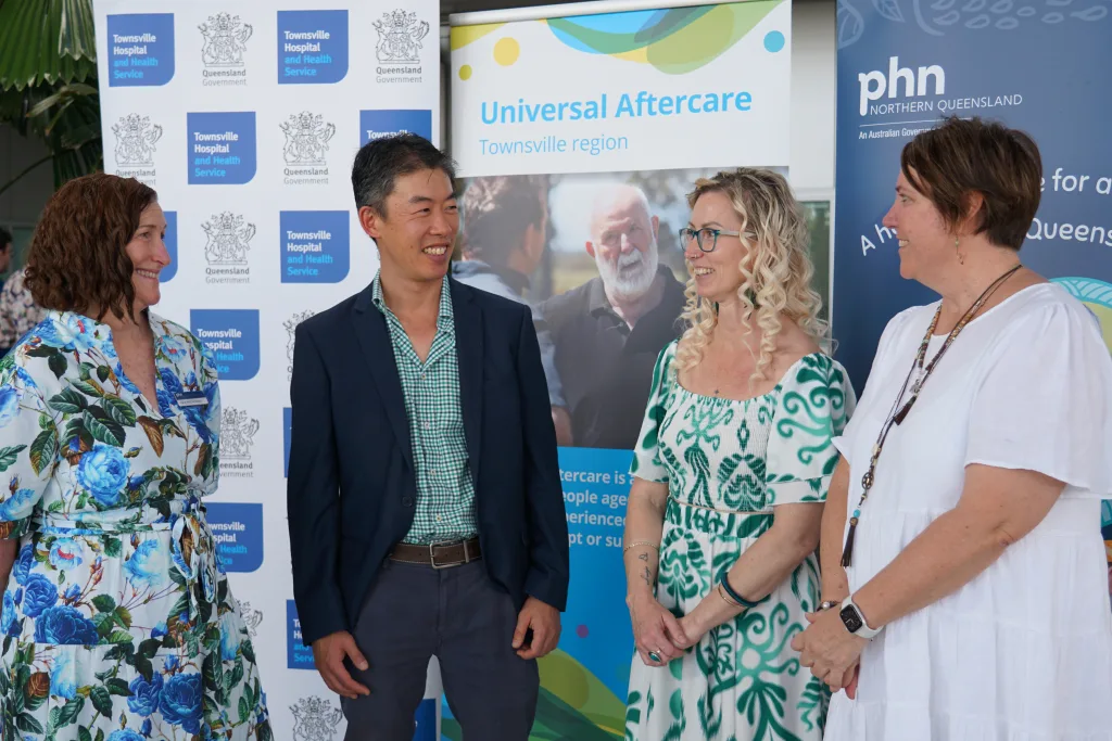 Partners and Lived experience representative smiling at the launch of Townsville UAC