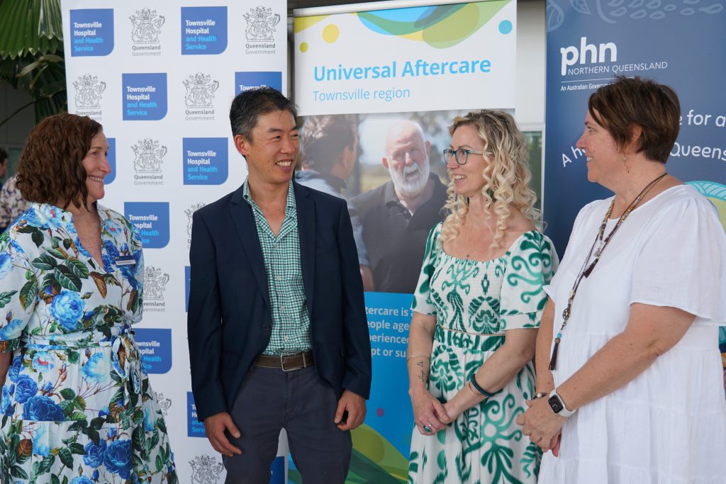 Partners and Lived experience representative smiling at the launch of Townsville UAC